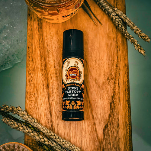 Small bottle with label on a wooden board with wheat stalks