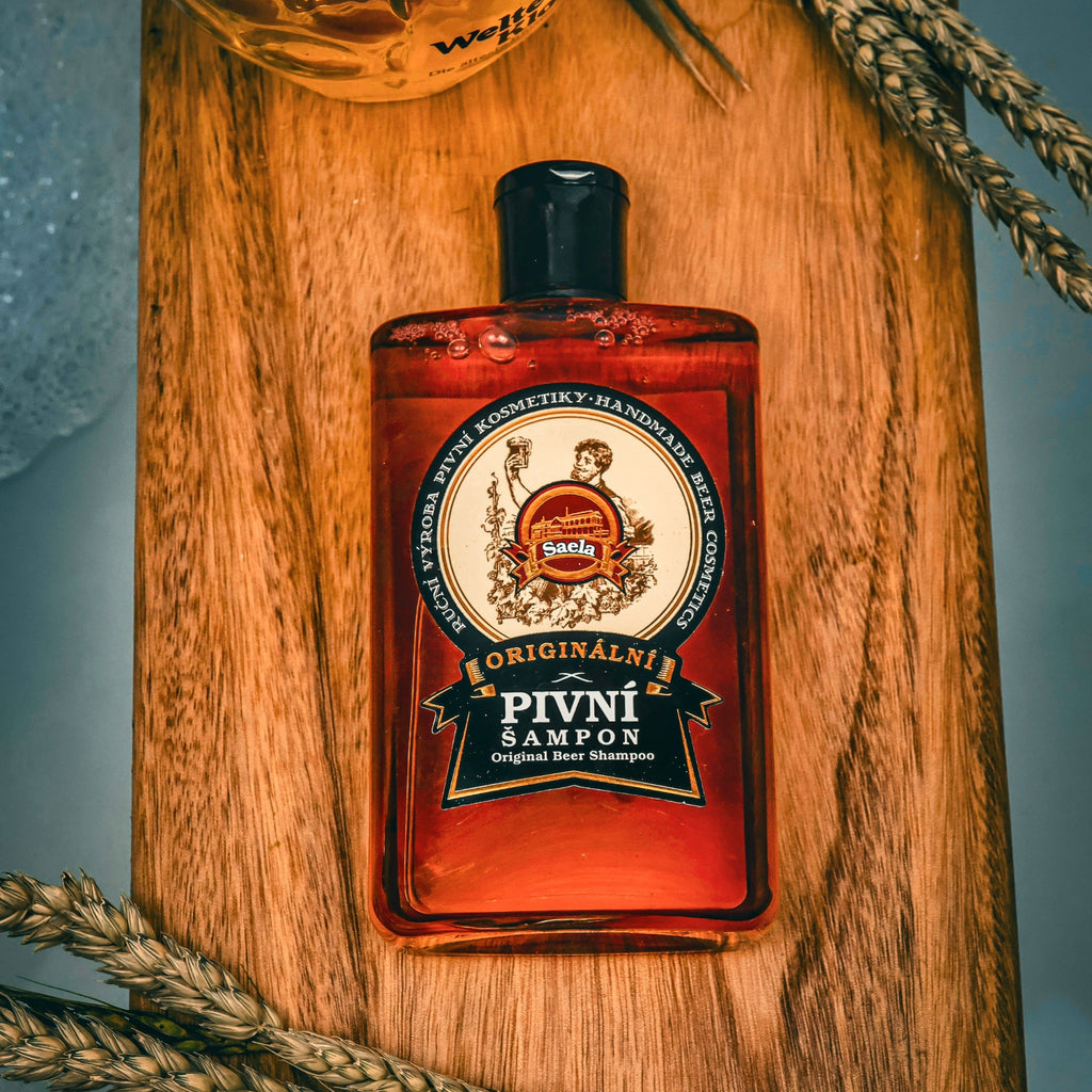 Red bottle with a label on a wooden surface with wheat stalks