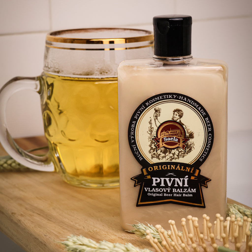 Bottle of 'Pivni' beer balm with a glass of beer and wheat on a wooden surface.