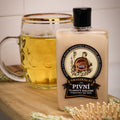 Bottle of 'Pivni' beer balm with a glass of beer and wheat on a wooden surface.